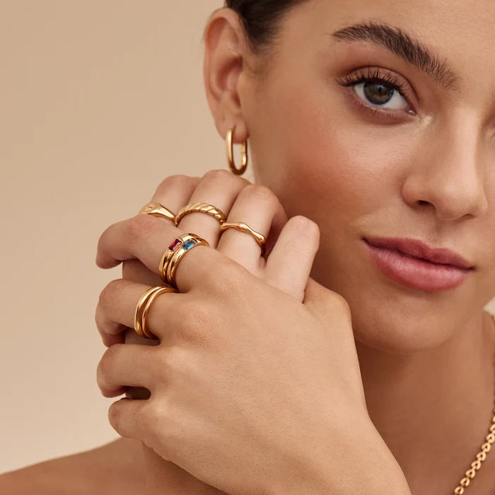 Gold birthstone band ring flat lay — Olivia Jewelry