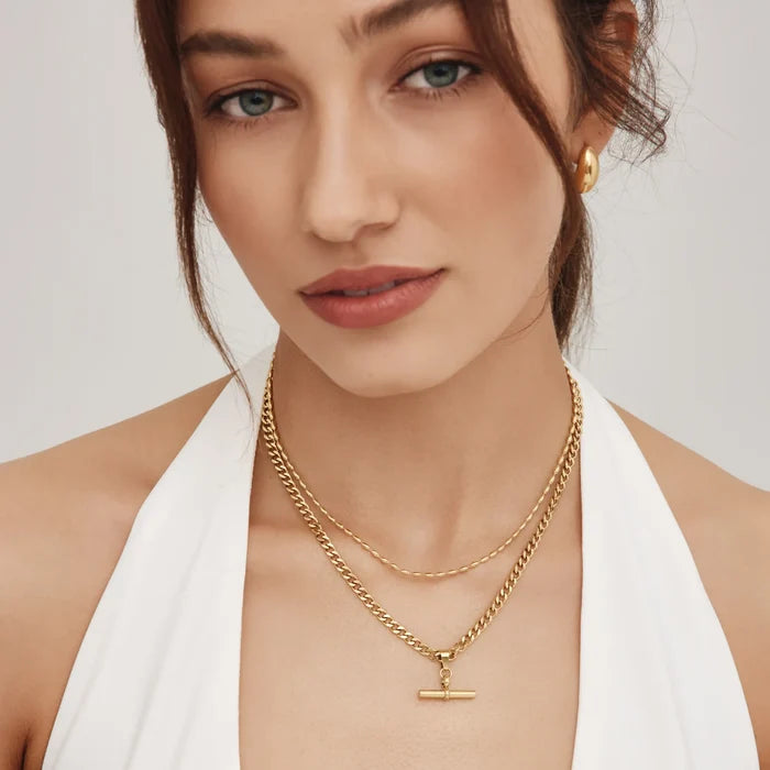 Curb chain fob necklace layered with a finer gold chain on model — Olivia Jewelry