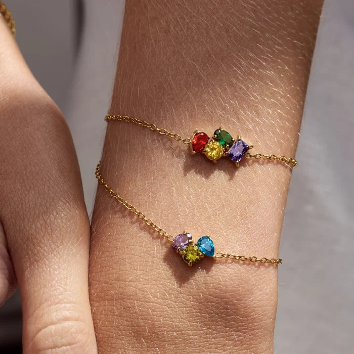 Custom Legacy Birthstone Bracelets with four and three birthstones worn on wrist in sunlight