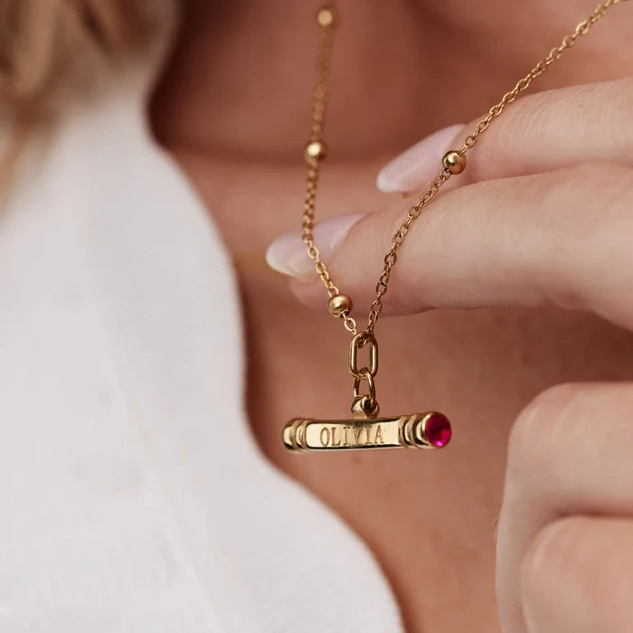Custom Name Birthstone T-Bar Necklace close-up engraved Olivia with red birthstone end