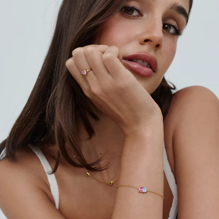 Model wearing Forever Duo Birthstone Bracelet with pink and blue stones and gold heart ring — Olivia Jewelry