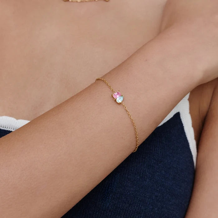 Forever Duo Birthstone Bracelet with pink and aquamarine stones worn on wrist close-up