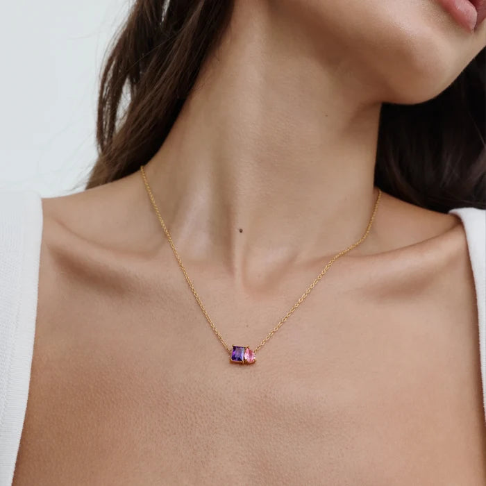 Forever Duo Birthstone Necklace with purple and pink stones worn at the collarbone