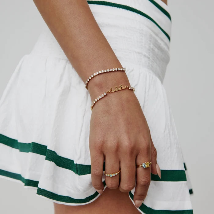 Signature Name Tennis Bracelet personalised as Isabella layered with tennis bracelet on model